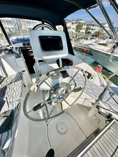 To The Gills Yacht Photos Pics 2014 Hunter 33 sailboat cockpit with steering wheel and navigation equipment.