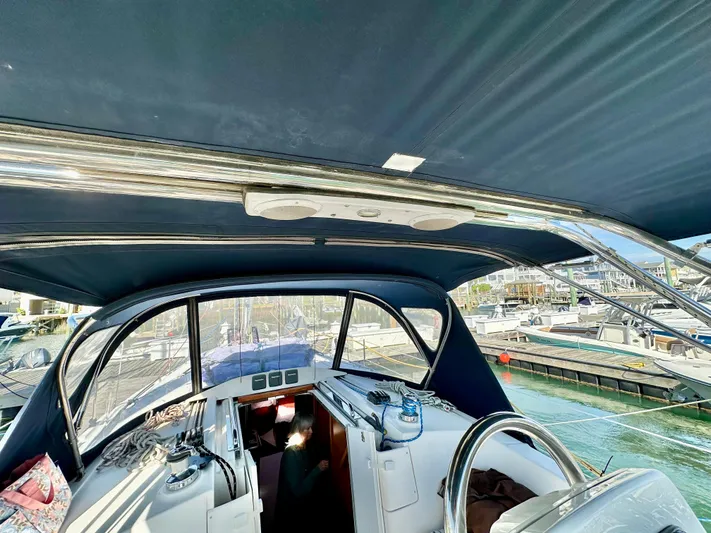 To The Gills Yacht Photos Pics 2014 Hunter 33 sailboat cockpit with blue canopy and marina view.