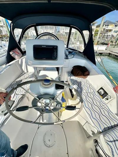 To The Gills Yacht Photos Pics 2014 Hunter 33 sailboat cockpit with steering wheel and navigation equipment.