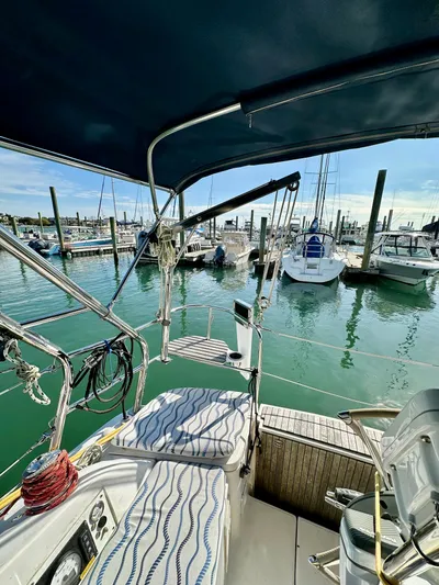 To The Gills Yacht Photos Pics 2014 Hunter 33 sailboat docked at marina, featuring cockpit view and surrounding boats.