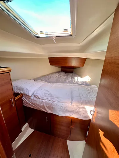 To The Gills Yacht Photos Pics 2014 Hunter 33 yacht interior cabin with skylight and wooden furnishings.