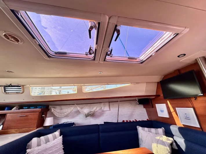 To The Gills Yacht Photos Pics Interior of 2014 Hunter 33 sailboat with skylights, seating, and TV.