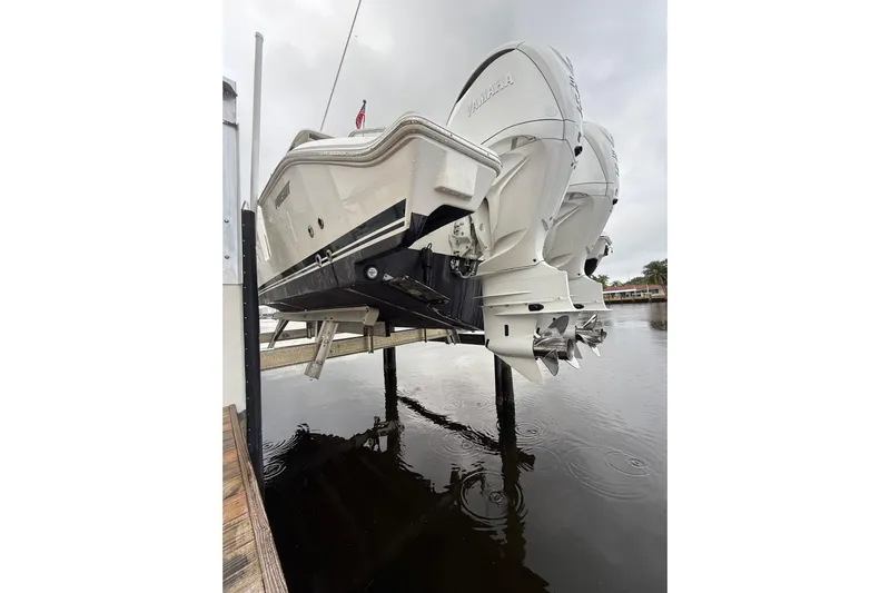  Yacht Photos Pics 2025 Pursuit OS 325 Offshore boat with dual Yamaha engines on a lift.