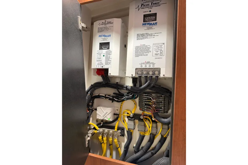  Yacht Photos Pics Electrical panel inside 2025 Pursuit OS 325 Offshore boat, featuring Newmar components.