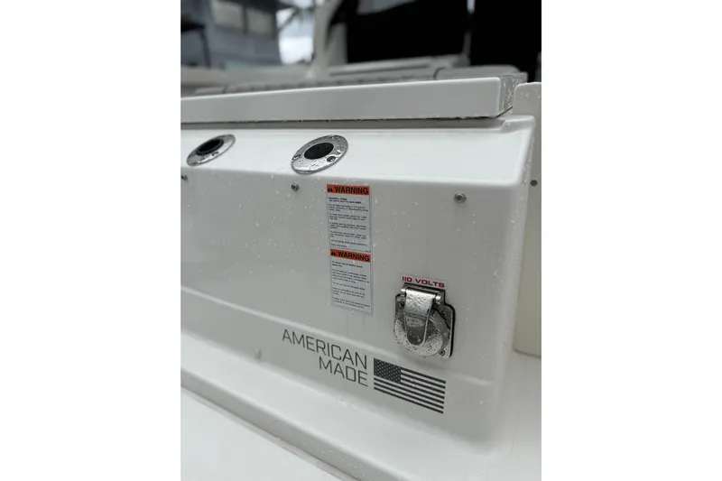  Yacht Photos Pics 2025 Pursuit OS 325 Offshore boat detail with American flag and warning labels.