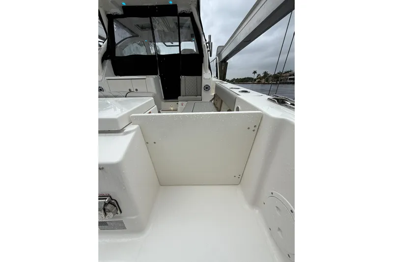  Yacht Photos Pics 2025 Pursuit OS 325 Offshore boat interior with sleek white design and modern features.