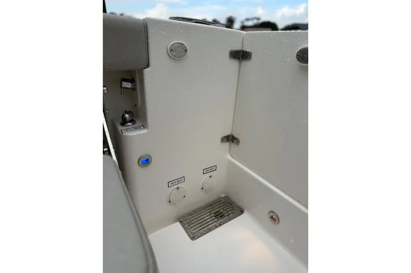  Yacht Photos Pics 2025 Pursuit OS 325 Offshore boat interior with fresh water controls and drainage system.