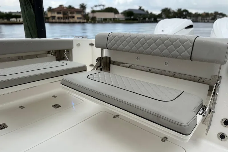  Yacht Photos Pics 2025 Pursuit OS 325 Offshore boat with luxurious gray seating and quilted design.