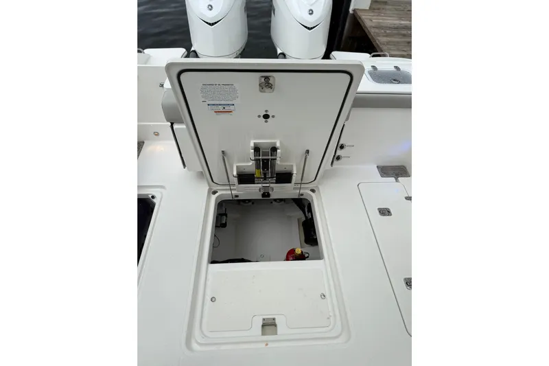  Yacht Photos Pics 2025 Pursuit OS 325 Offshore boat with open hatch revealing storage compartment.