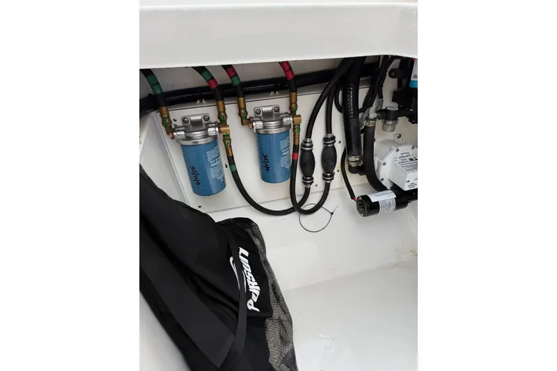  Yacht Photos Pics 2025 Pursuit OS 325 Offshore engine compartment with filters and hoses.