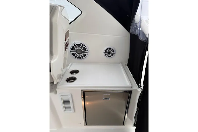  Yacht Photos Pics Interior of 2025 Pursuit OS 325 Offshore boat with speakers and compact fridge.