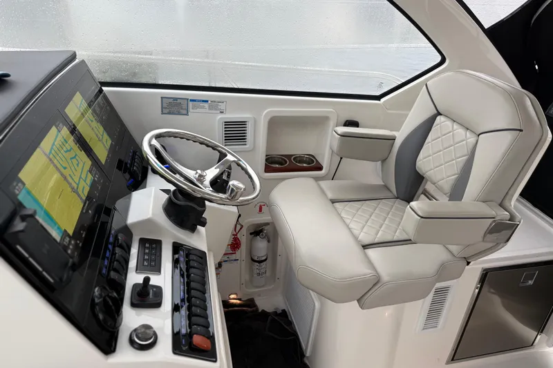  Yacht Photos Pics 2025 Pursuit OS 325 Offshore helm with modern controls and luxurious seating.
