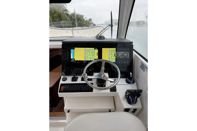  Yacht Photos Pics 2025 Pursuit OS 325 Offshore helm with dual navigation screens and modern controls.