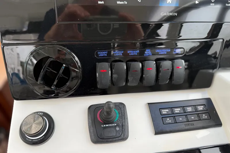  Yacht Photos Pics Control panel of 2025 Pursuit OS 325 Offshore boat with switches and navigation controls.