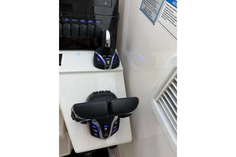  Yacht Photos Pics 2025 Pursuit OS 325 Offshore boat controls with illuminated buttons and sleek design.