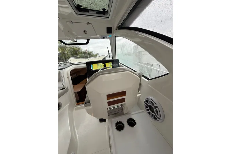  Yacht Photos Pics 2025 Pursuit OS 325 Offshore boat interior with modern dashboard and navigation screens.