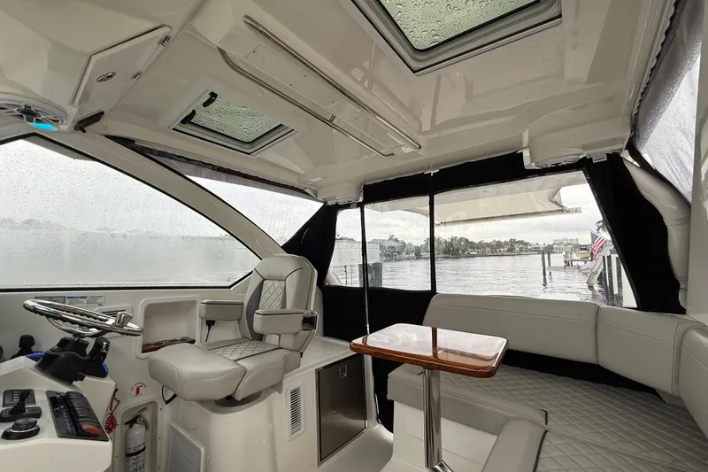  Yacht Photos Pics Interior of 2025 Pursuit OS 325 Offshore boat with seating and helm, overlooking water.