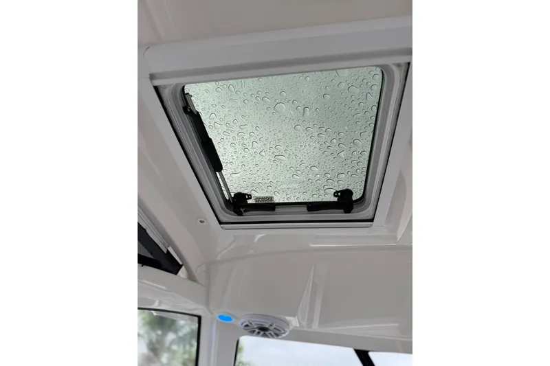  Yacht Photos Pics 2025 Pursuit OS 325 Offshore boat hatch with raindrops on glass.