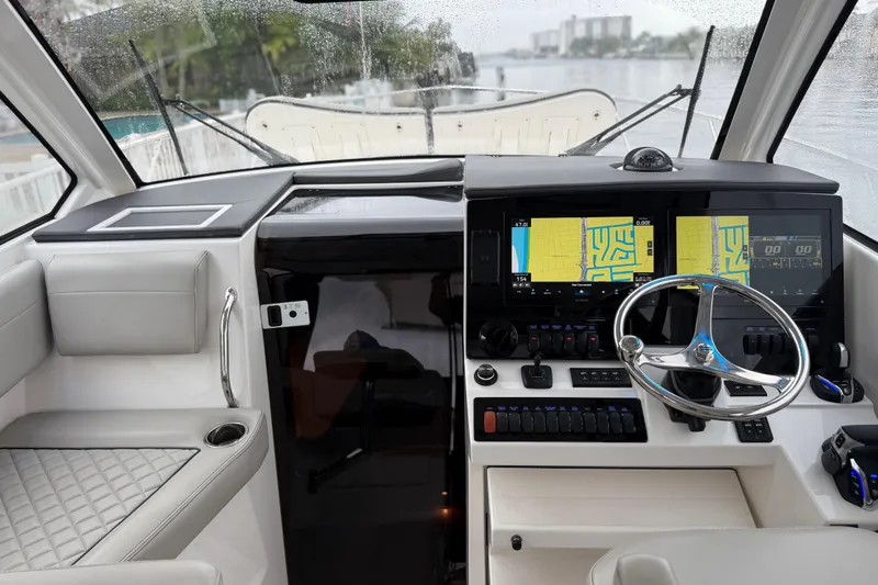  Yacht Photos Pics 2025 Pursuit OS 325 Offshore helm with dual navigation screens and modern controls.