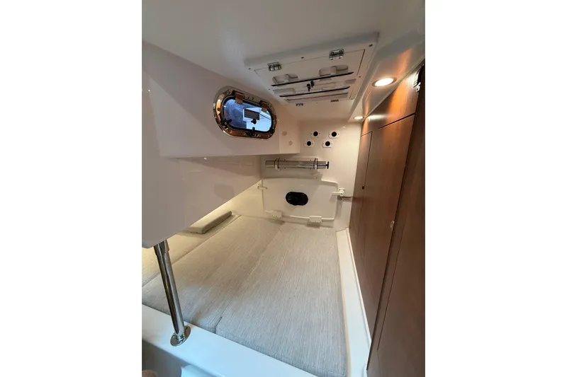  Yacht Photos Pics 2025 Pursuit OS 325 Offshore cabin interior with modern design and wood accents.