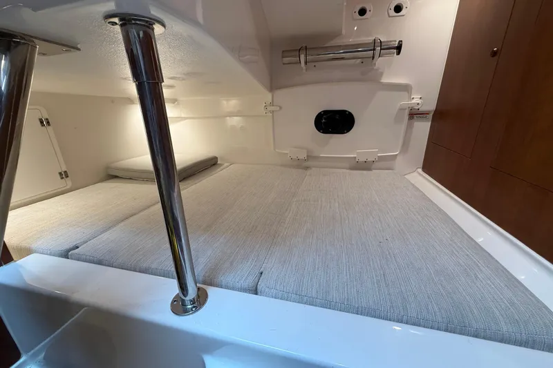  Yacht Photos Pics 2025 Pursuit OS 325 Offshore cabin interior with cushioned seating and storage compartments.