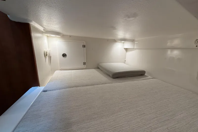  Yacht Photos Pics 2025 Pursuit OS 325 Offshore cabin interior with cozy sleeping area.