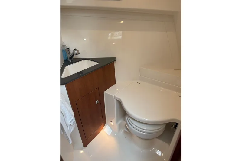  Yacht Photos Pics 2025 Pursuit OS 325 Offshore boat bathroom with sink and toilet.