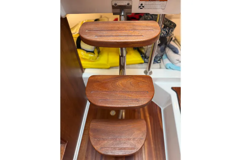  Yacht Photos Pics Wooden steps on a 2025 Pursuit OS 325 Offshore boat interior.