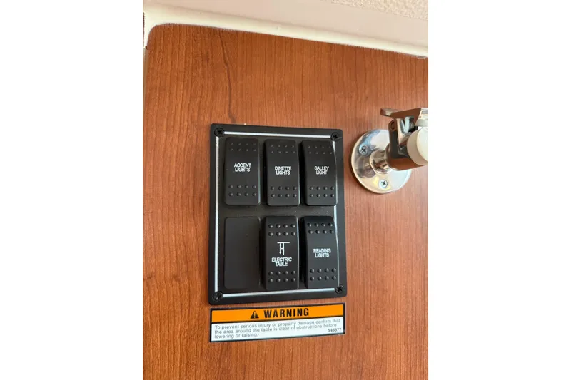  Yacht Photos Pics Control panel on 2025 Pursuit OS 325 Offshore boat with labeled light switches.