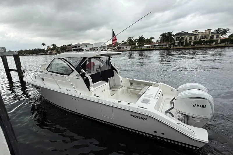  Yacht Photos Pics 2025 Pursuit OS 325 Offshore boat with Yamaha engines on a calm waterway.