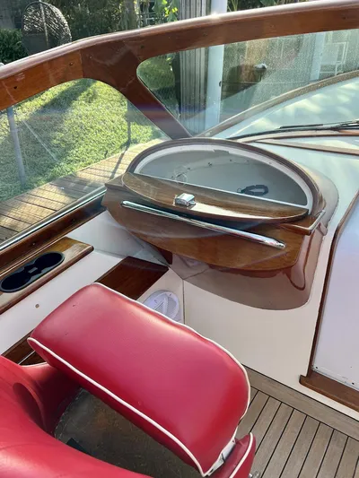 Le Ti Yacht Photos Pics 2004 Hinckley Talaria 29R boat interior with red seating and wooden dashboard.