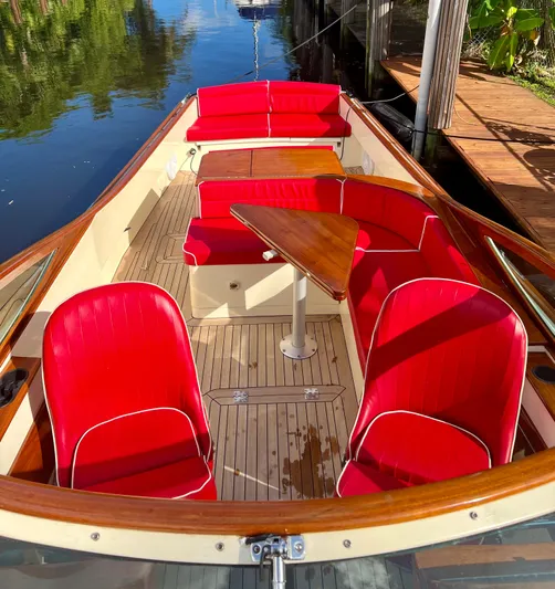 Le Ti Yacht Photos Pics 2004 Hinckley Talaria 29R boat with red seating and wooden deck.