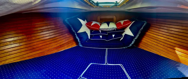 Le Ti Yacht Photos Pics Interior cabin of 2004 Hinckley Talaria 29R with nautical-themed bedding.