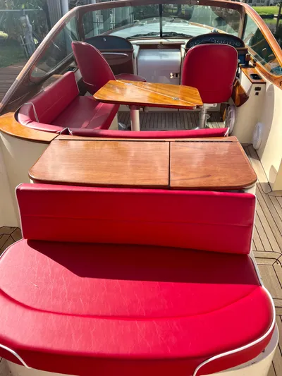 Le Ti Yacht Photos Pics 2004 Hinckley Talaria 29R boat interior with red leather seats and wooden table.