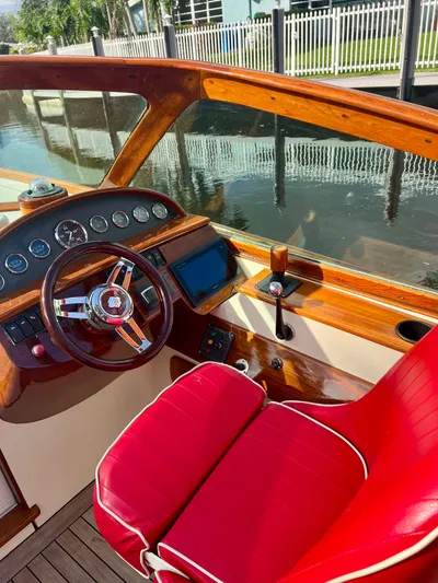 Le Ti Yacht Photos Pics 2004 Hinckley Talaria 29R boat interior with red leather seat and wooden dashboard.