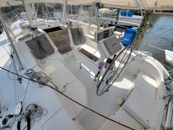 Prairie Wind Yacht Photos Pics 2003 Catalina 42 Mk2 sailboat cockpit with steering wheel, ropes, and seating at marina.