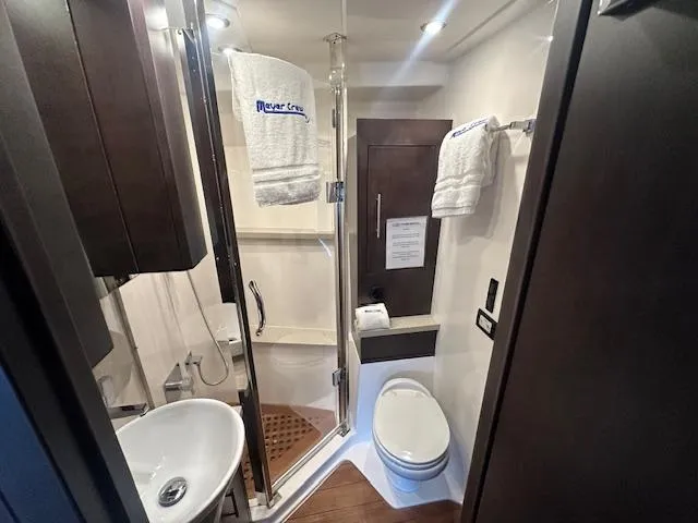  Yacht Photos Pics Bathroom interior of 2017 Regal 53 Sport Coupe yacht, featuring modern fixtures and elegant design.