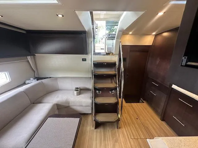  Yacht Photos Pics Luxurious interior of 2017 Regal 53 Sport Coupe yacht with modern furnishings and wooden flooring.
