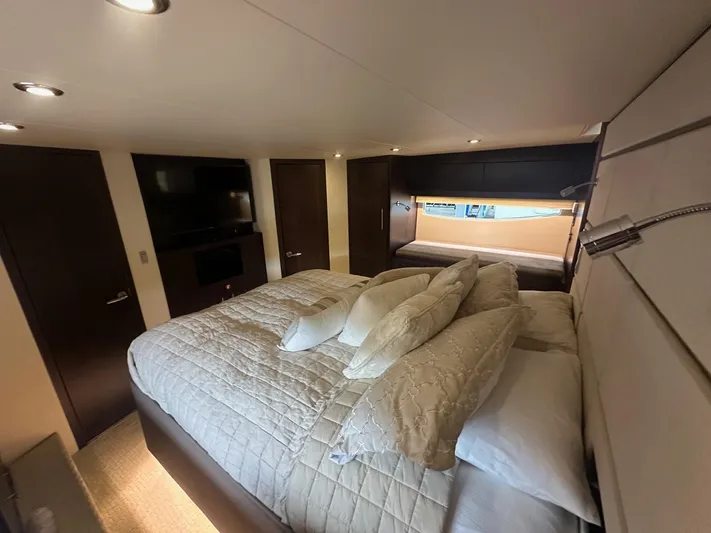  Yacht Photos Pics Luxurious bedroom interior of 2017 Regal 53 Sport Coupe yacht with elegant bedding and modern lighting.