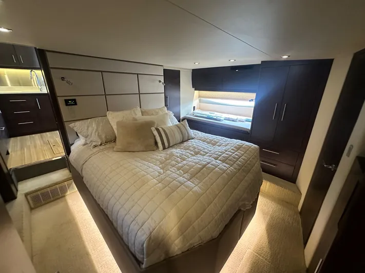  Yacht Photos Pics Luxurious bedroom interior of 2017 Regal 53 Sport Coupe yacht, featuring elegant bedding and modern design.