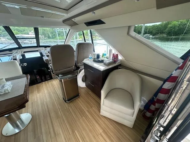  Yacht Photos Pics Interior of 2017 Regal 53 Sport Coupe yacht with seating and helm, featuring modern design.