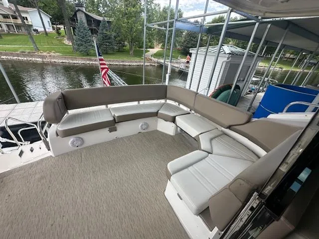 Yacht Photos Pics 2017 Regal 53 Sport Coupe boat with spacious outdoor seating area by a lakeside dock.