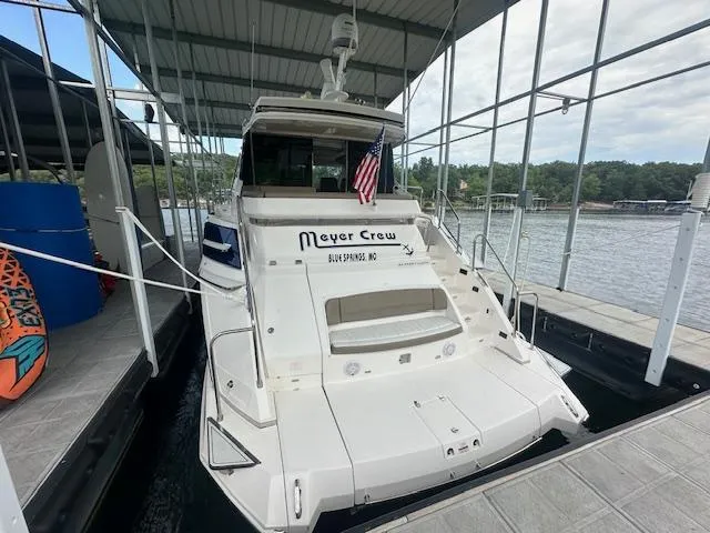  Yacht Photos Pics 2017 Regal 53 Sport Coupe docked, displaying an American flag, with lake view.