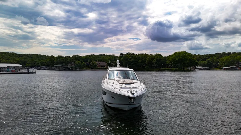  Yacht Photos Pics 2017 Regal 53 Sport Coupe yacht on a serene lake under a cloudy sky.