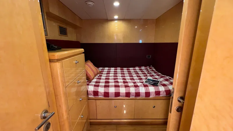 Missy B II Yacht Photos Pics Cozy bedroom in 2005 Hargrave Custom Yacht with checkered bedding and wooden cabinetry.