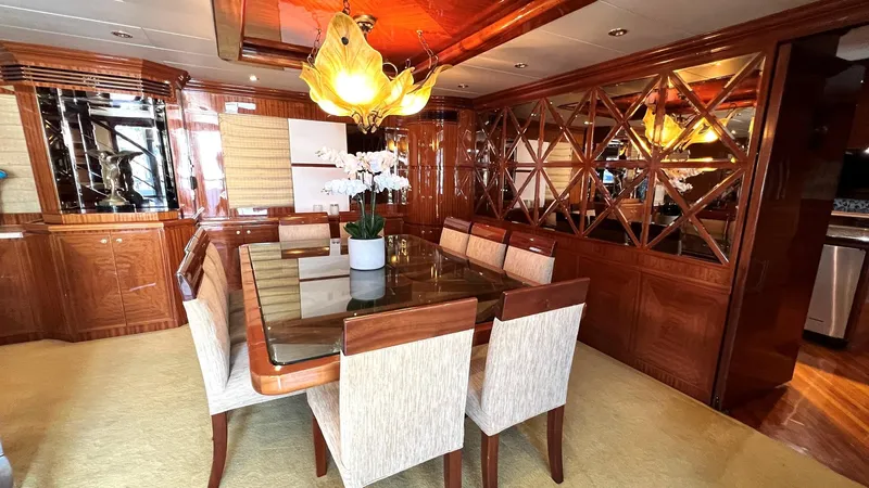 Missy B II Yacht Photos Pics Luxurious dining area on a 2005 Hargrave Custom Yacht with elegant wood finishes and modern decor.