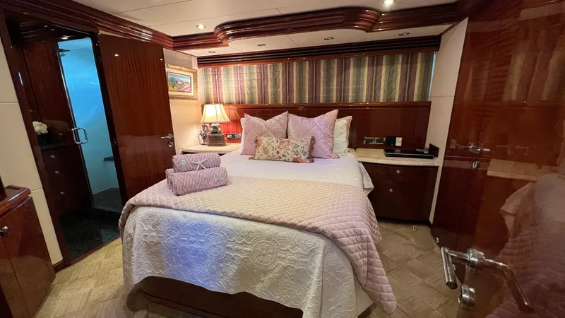 Missy B II Yacht Photos Pics Luxurious bedroom interior of a 2005 Hargrave Custom Yacht with elegant bedding and wood finishes.
