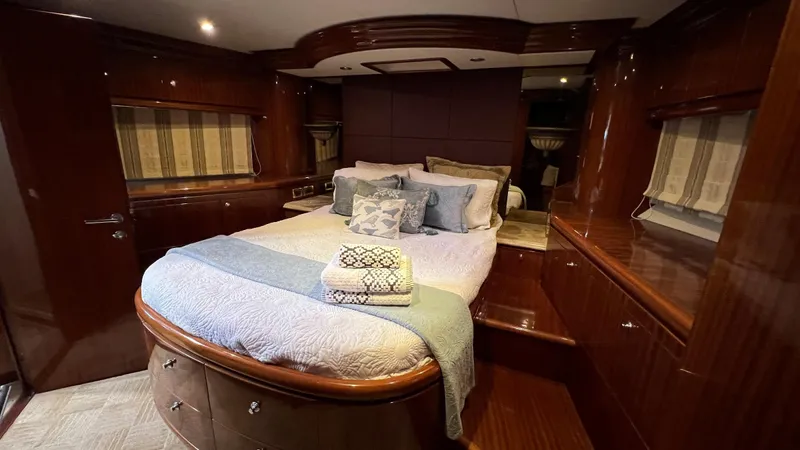 Missy B II Yacht Photos Pics Luxurious bedroom interior of a 2005 Hargrave Custom Yacht with elegant wood finishes.