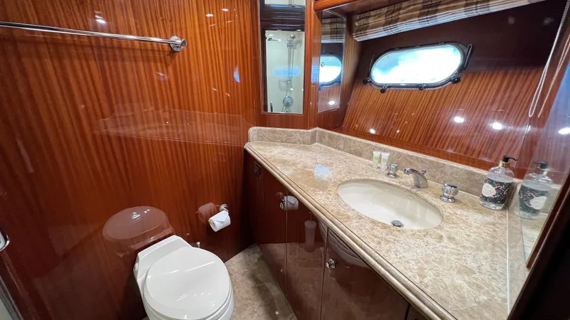 Missy B II Yacht Photos Pics Luxurious bathroom in a 2005 Hargrave Custom Yacht with wood paneling and marble countertop.