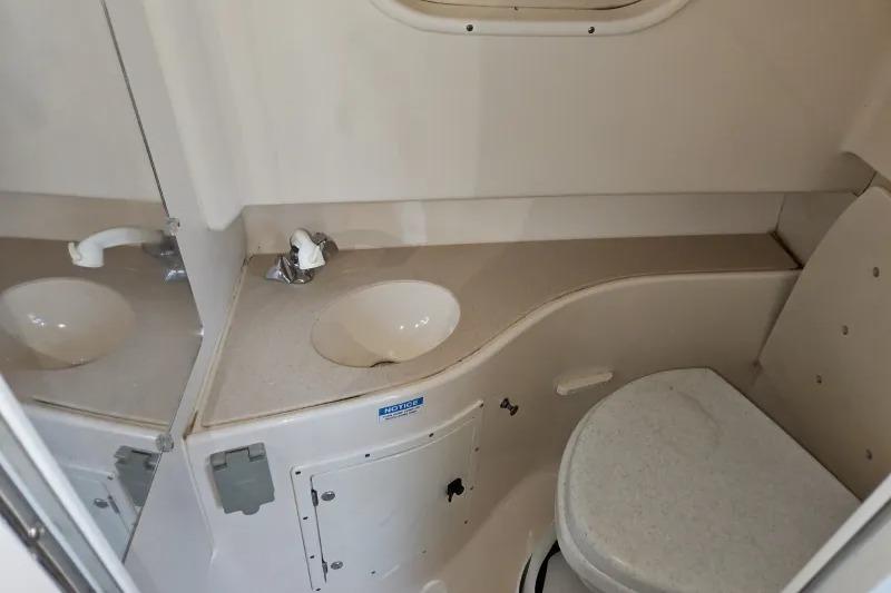 2001 Pursuit 2870 Walkaround boat bathroom with sink and toilet.